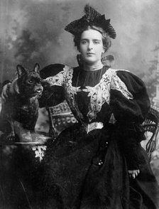 Natalie Barney seated with dog, 1910. Creator: Bain News Service.