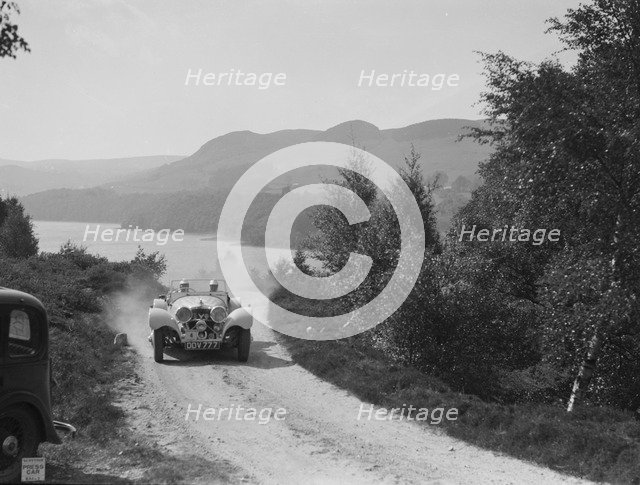 SS Jaguar 100 open 2-seater of Miss E Violet Watson competing in the RSAC Scottish Rally, 1939. Artist: Bill Brunell.