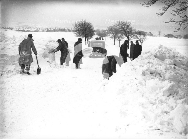 German/Italian prisoners of war clearing snow on Fairfield Common, Buxton, Derbyshire, 1947. Artist: JD Meddins