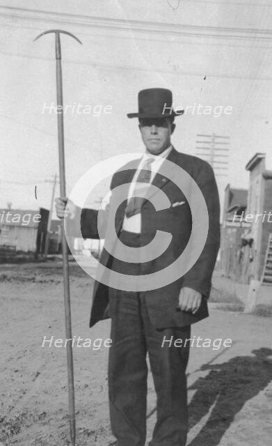 Man holding a tool, between c1900 and 1916. Creator: Unknown.