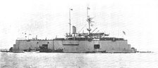 A battle-ship docked on the water: H.M.S. "Sans Pareil" on a floating-dock in the Tyne, 1909. Creator: L.N.A..