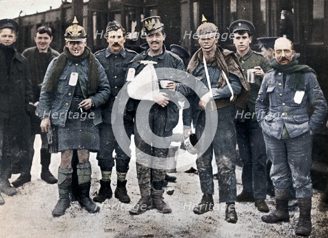 Some cheerful wounded from the Neuve Chapelle fighting, wearing captured German helmets, 1915. Artist: Unknown.