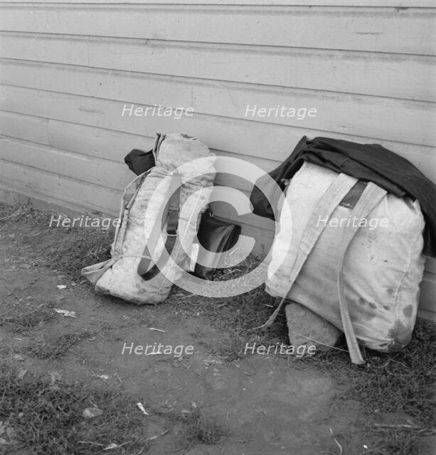 Bindles on shady side of Pastime Café, Tulelake, Siskiyou County, California, 1939. Creator: Dorothea Lange.