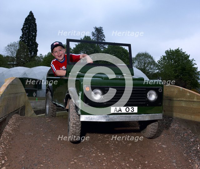Child driving a toy Land Rover. Artist: Unknown.