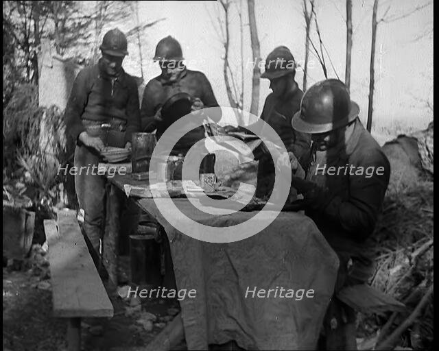 French Soldiers Eating a Meal in a Dug Out, 1940. Creator: British Pathe Ltd.