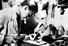 Making wooden shoe soles, German-occupied Paris, February 1941. Artist: Unknown