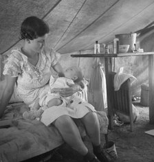Young migrant mother with six weeks old baby born in a hospital with aid..., near Westley, CA, 1939. Creator: Dorothea Lange.