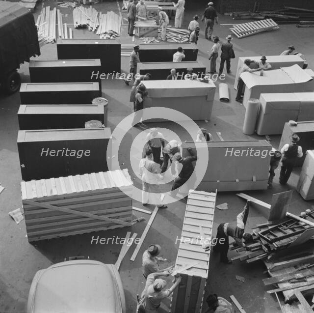 United States government workers and carpenters making crates for steel..., Washington, D.C., 1942. Creator: Gordon Parks.