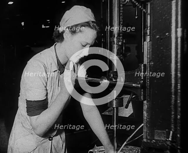 Woman Working in a Factory, 1940. Creator: British Pathe Ltd.