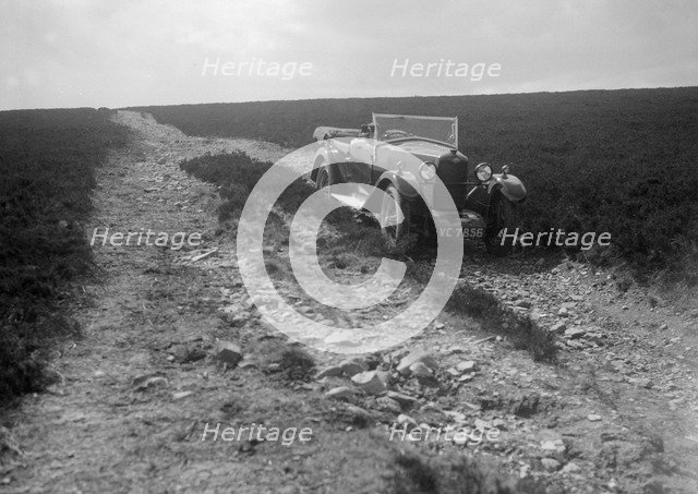 Kitty Brunell road testing a Riley 9 WD tourer, c1930. Artist: Bill Brunell.