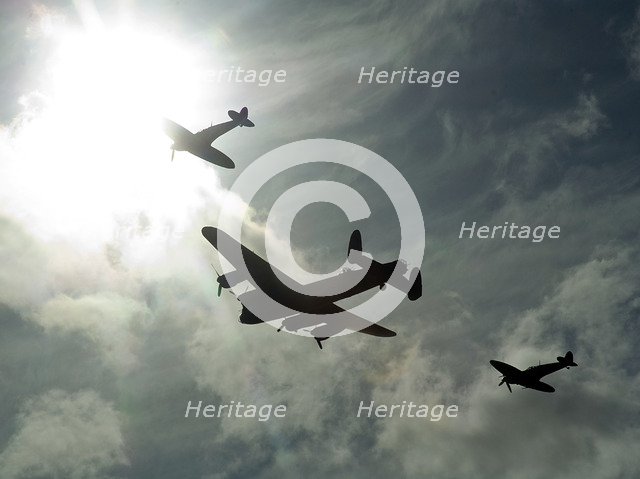 2011 Goodwood Revival Meeting, Lancaster bomber and 2 Spitfires in aerial display. Artist: Unknown.