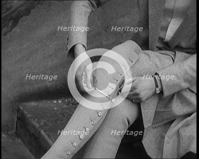 Female Civilian Using a Button Hook to Button up Her Leather Boots, 1920. Creator: British Pathe Ltd.