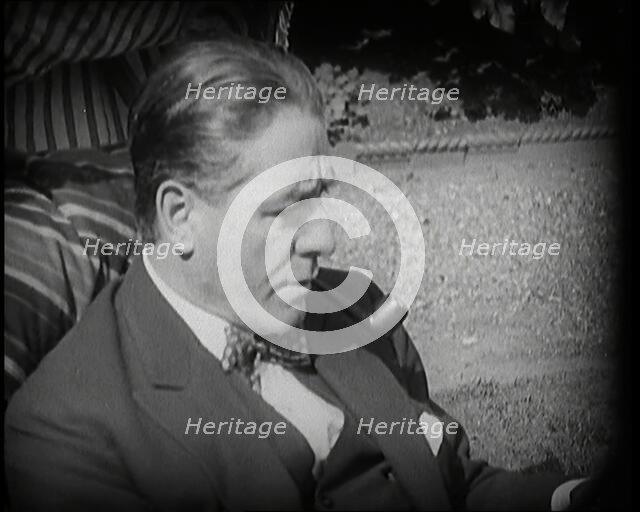 Matheson Lang Relaxing in a Deck Chair Smoking a Pipe, 1920s. Creator: British Pathe Ltd.