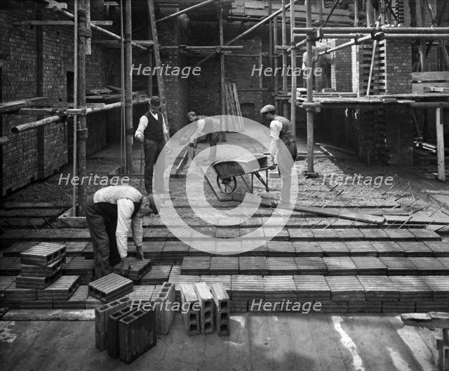 Construction workers laying a hollow pot floor, 8 Lloyds Avenue, City of London, 1907. Artist: Bedford Lemere and Company.