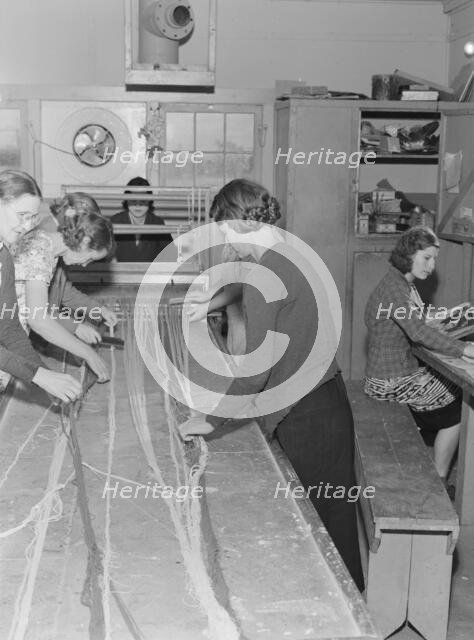 In the sewing room, Shafter camp for migrants (FSA,) California, 1938. Creator: Dorothea Lange.