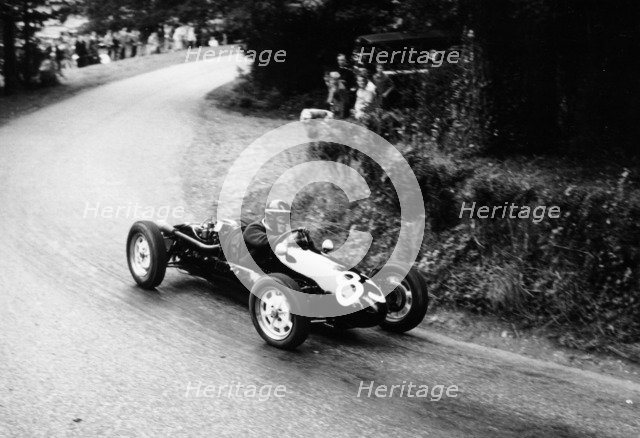 A racing driver speeding round a bend, Harleyford Hill Climb, Buckinghamshire, (c1950-c1960?). Artist: Unknown