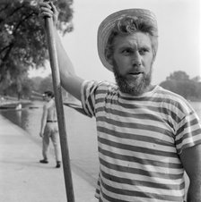 An boatman wearing a stripey T-shirt and a straw boater, Greater London, c1946-c1959. Artist: John Gay