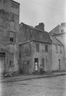 Woman and child standing in or by a doorway, [17 Chalmers Street], Charleston, South Ca., c1920-1926 Creator: Arnold Genthe.