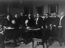 Cabinet Room, White House, Aug. 12, 1898. Secy. of State William R. Day signing, c1898. Creator: Frances Benjamin Johnston.