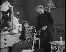 Female Civilian Having Her Hair Cut Into a 'Shingle' by a Male Civilian Hairdresser, 1920. Creator: British Pathe Ltd.