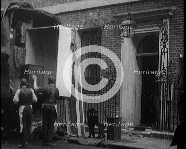 Two Male Civilians Load Furniture Into a Van Outside of 10 Downing Street, 1924. Creator: British Pathe Ltd.