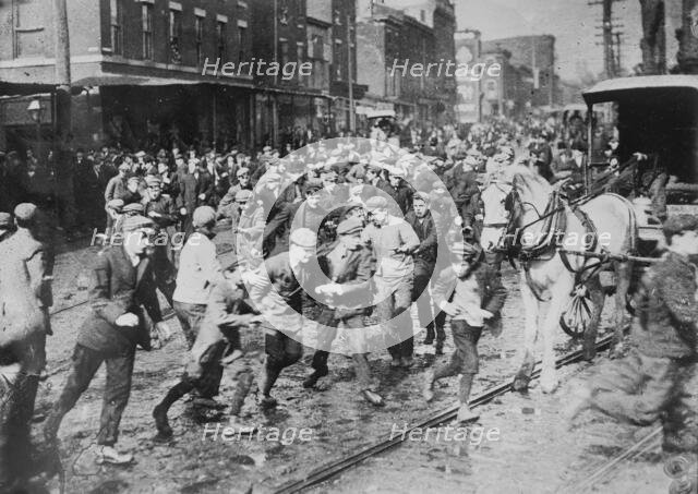 Rioters charging horse-drawn car, later wrecking it on Kensington Ave., Philadelphia, 1910. Creator: Bain News Service.
