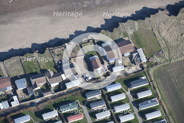 Bungalows at risk from coastal erosion, Green Lane, near Skipsea, East Riding of Yorkshire, 2014. Creator: Historic England Staff Photographer.
