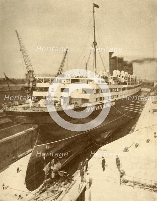 'Overhauling a Large Liner in a Graving Dock at Liverpool', c1930. Creator: Unknown.