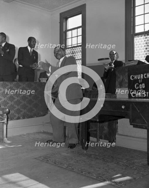 Deacons' corner during Sunday morning service at the Church of God in Christ, Washington, DC, 1942. Creator: Gordon Parks.