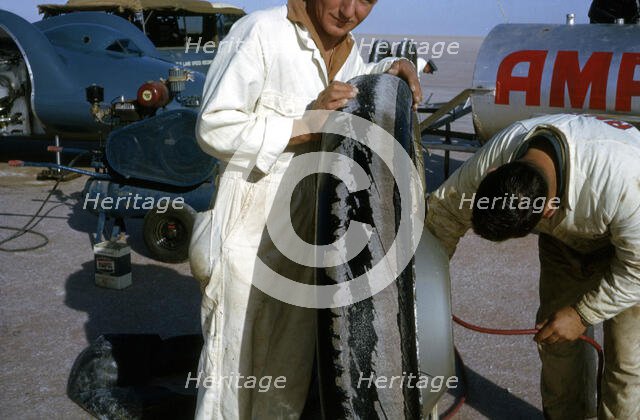 Mechanics inflating Bluebird CN7 tyre for World Land Speed Record attempt, Lake Eyre, 1964. Creator: Unknown.