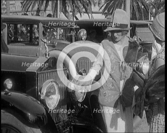 Two Female Civilians Wearing Glamorous Outfits Admiring a Luxurious Car, 1920. Creator: British Pathe Ltd.