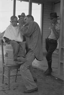 Community barber shop in Kern County migrant camp, California, 1936. Creator: Dorothea Lange.
