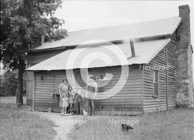 Tobacco sharecroppers and family at back of their house, Person County, North Carolina, 1939. Creator: Dorothea Lange.