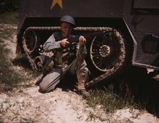 A young soldier of the armored forces holds and sights his Garand rifle like..., Fort Knox, Ky, 1942 Creator: Alfred T Palmer.