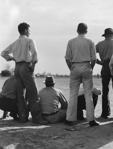 Watching ball game, Shafter camp for migrants, California, 1939. Creator: Dorothea Lange.