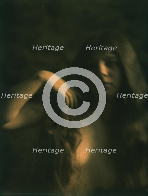 Girl wearing a white dress and a boy wearing a sailor suit standing behind flowers, c1906-c1942. Creator: Arnold Genthe.