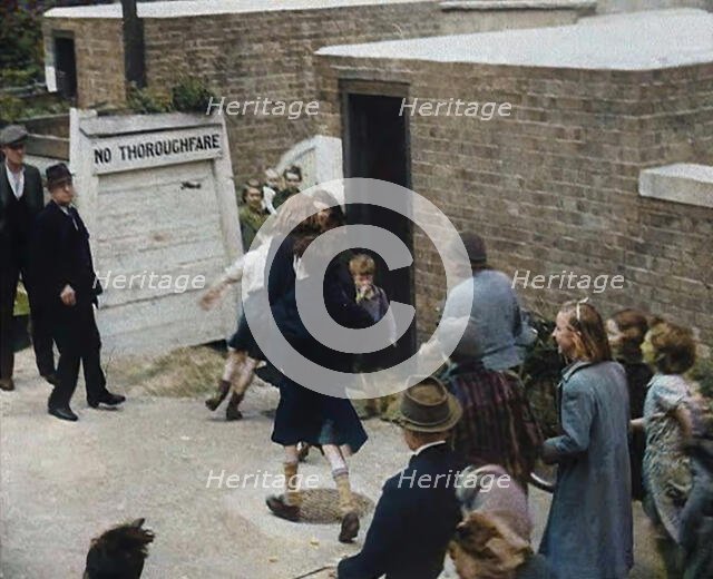 Civilians Entering an Air Raid Shelter to Escape German Shelling, 1940. Creator: British Pathe Ltd.