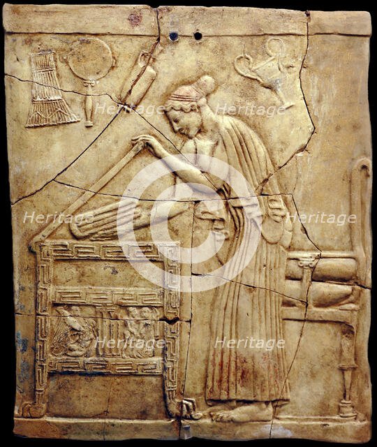 Relief pinax from Locri depicting a woman placing laundry in a laundry chest, Mid of the 5th cen. BC Creator: Classical Antiquities.
