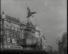 The Eros Statue in Piccadilly Circus With Neon Advertising Lights on the Buildings Behind..., 1939. Creator: British Pathe Ltd.