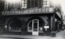 The front door of the Pharmacie du Cerf on the corner of the street, Strasbourg, c1900s.. Creator: Unknown.