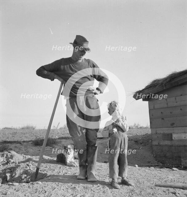 Mr. Dougherty and one of the children, Warm Springs district, Malheur County, Oregon, 1939. Creator: Dorothea Lange.