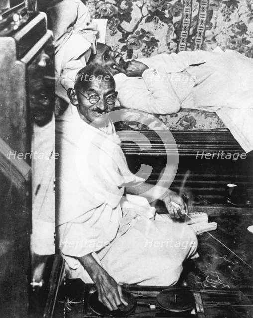 Mohondas Karamchand Gandhi (1869-1948), working at his spinning wheel. Artist: Unknown
