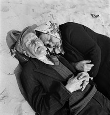 An elderly couple doze on the beach, Blackpool, c1946-c1955. Artist: John Gay