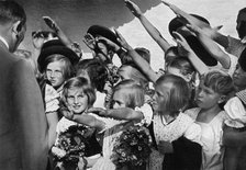 Adolf Hitler with a group of young children, 1936. Artist: Unknown