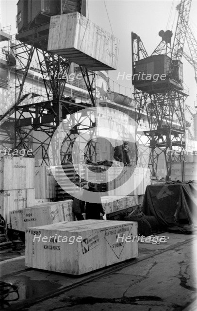 Cased car parts bound for Australia being loaded, King George V Dock, London, c1945-c1965. Artist: SW Rawlings