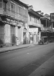 View down a street, New Orleans, between 1920 and 1926. Creator: Arnold Genthe.