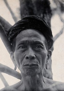 Sarawak: Tama Kulieng, a chief of the Butang Kayan River tribe, c1900.. Creator: Unknown.