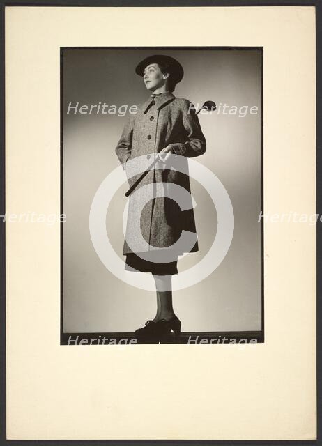 Woman modeling coat with golf club, early 1940s. Creator: Gunther Krampf.