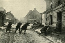 French troops crossing a village street under German fire, First World War, 1914-1915, (c1920). Creator: Unknown.