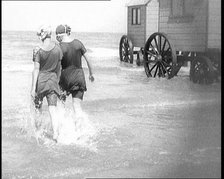 Two Female Civilians in Bathing Suits Walking Through Shallow Water Away from the Camera..., 1924. Creator: British Pathe Ltd.